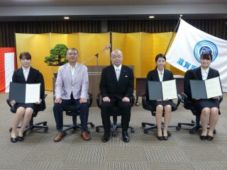 写真：塩田学長と角野次長と修了生