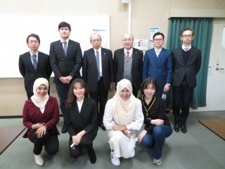 International students with the university president and faculty