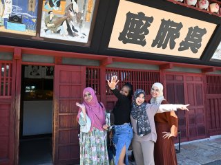Posing in front of a theater from Meiji era